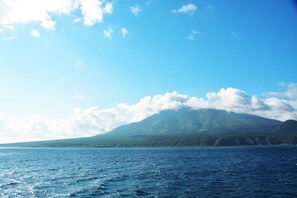 A clear view of a mountain range with a body of water in the foreground. - Island Inn Rishiri (Rishiri)