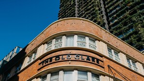A building with a curved facade, large windows, and the name "THE GOLD CLAIR" prominently displayed. - The Old Clare by Ode Hotels (Chippendale)
