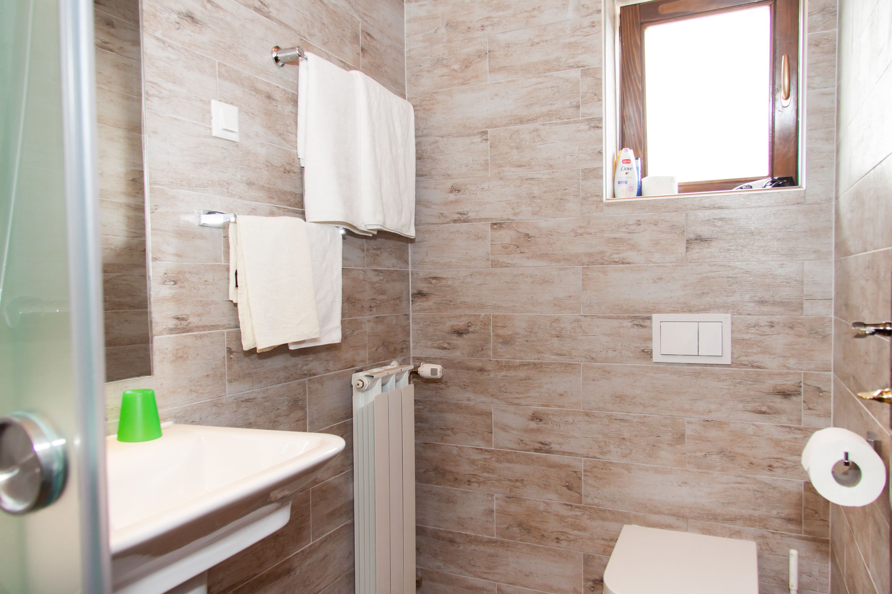 A bathroom with a shower, toilet, and sink.