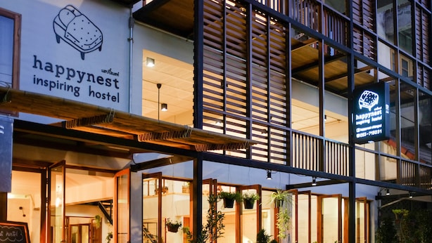 A hostel with a sign reading "happynest inspiring hostel" and a contact number. - Happynest Inspiring Hostel (Chiang Rai)