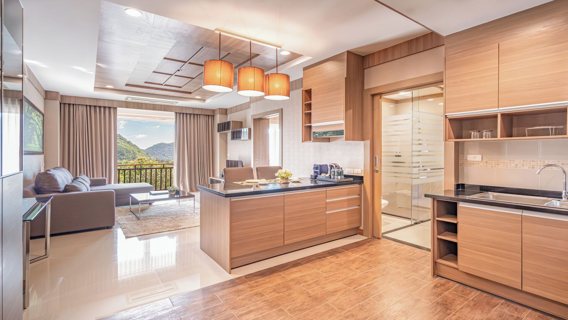 A modern kitchen with wooden cabinets, a central island, and pendant lighting.