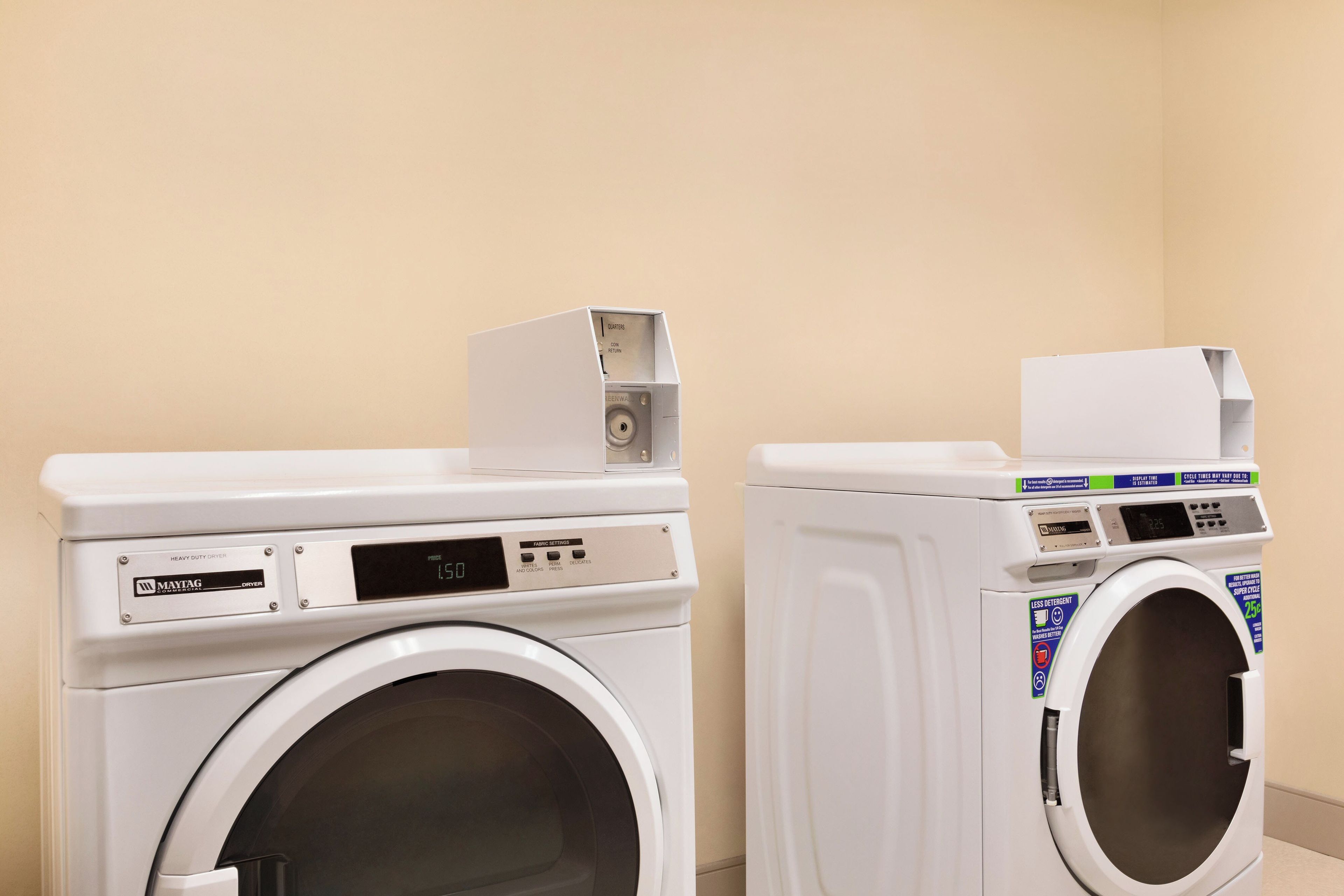 Two front-loading washing machines in a laundry room.