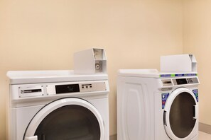 Two front-loading washing machines in a laundry room. - Four Points by Sheraton Fargo Medical Center (Fargo)