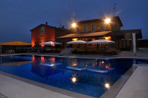 Una piscina con un edificio al fondo.
