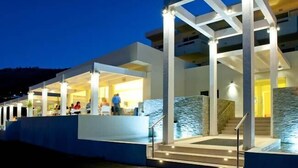 A modern building with a covered outdoor area, a staircase, and a pool. - Lindos White Hotel & Suites (Rhodes)