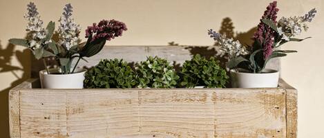 A wooden planter shelf with potted plants.