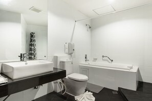 A modern bathroom with a white sink, toilet, and bathtub. - Prelude Hotel (Kanchanaburi)