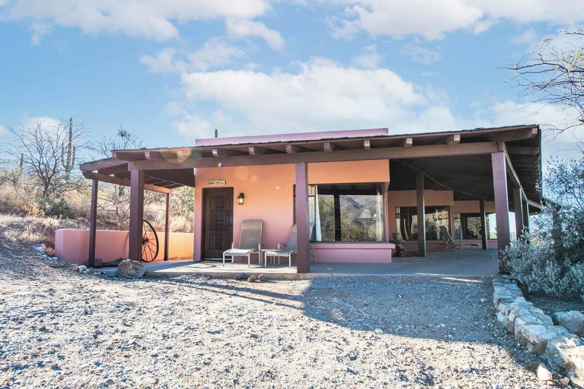 A single-story building with a covered patio area, a wheelchair-accessible entrance, and a gravel driveway.