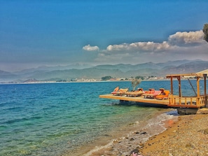 Private beach, black sand, sun loungers, beach towels