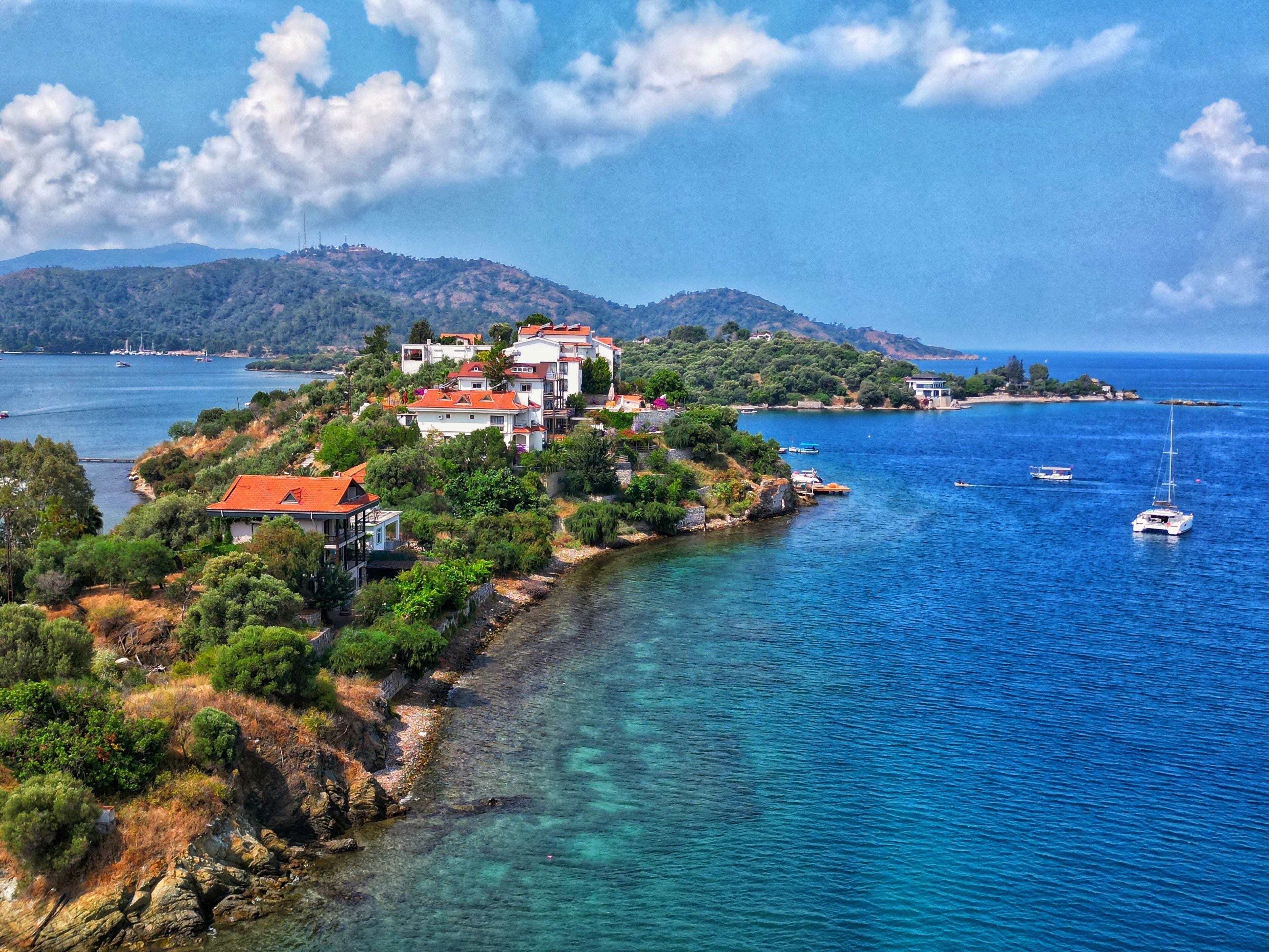 A coastal village with houses on a hillside overlooking the sea.