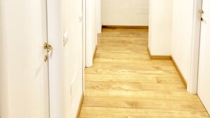 A hallway with white doors and a wooden floor. - Bella Cagliari B&B (Cagliari)