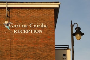 A brick building with a sign that reads "Gort na Coirib Reception".