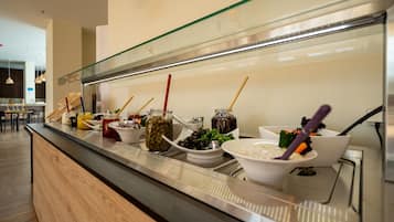 Un buffet proposant une variété de plats et d’ustensiles.