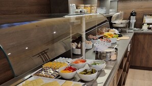 A buffet with various food items including meats, cheeses, and fruits. - Hotel Drei Kronen Elmshorn (Elmshorn)