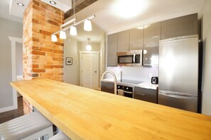 Suite Signature, 1 grand lit, balcon | Cuisine privée