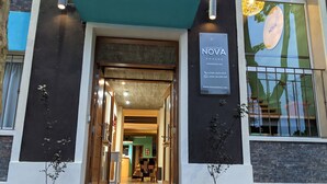 A hotel entrance with a sign reading "NOVA POSADA" and contact information. - Nova Posada (Colonia del Sacramento)