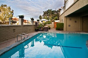 Outdoor pool, open 9:00 AM to 9:00 PM, pool umbrellas, pool loungers