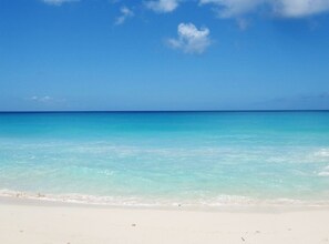 On the beach, sun loungers, beach umbrellas, beach towels - Serenity Cottages (Shoal Bay)