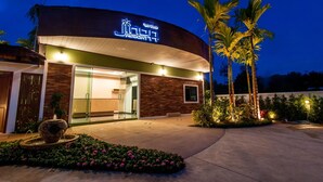 A modern resort building with a curved facade, a visible entrance, and a well-lit exterior. - Jinda Resort (Sa Khu)