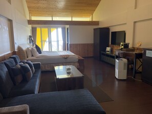 A modern room with a bed, sofa, desk, and a large window. - Cingjing Brilliant Twins of Seattle (Ren'ai)