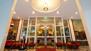 A hotel entrance with a glass door, a chandelier, and potted plants. - Lakeside Resort Hotel (Puli)