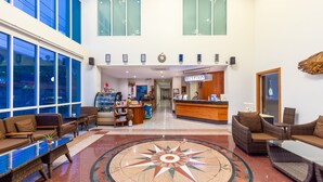 A hotel lobby with a reception desk, seating area, and a large decorative compass floor design. - Kanchanaburi City Hotel (Kanchanaburi)