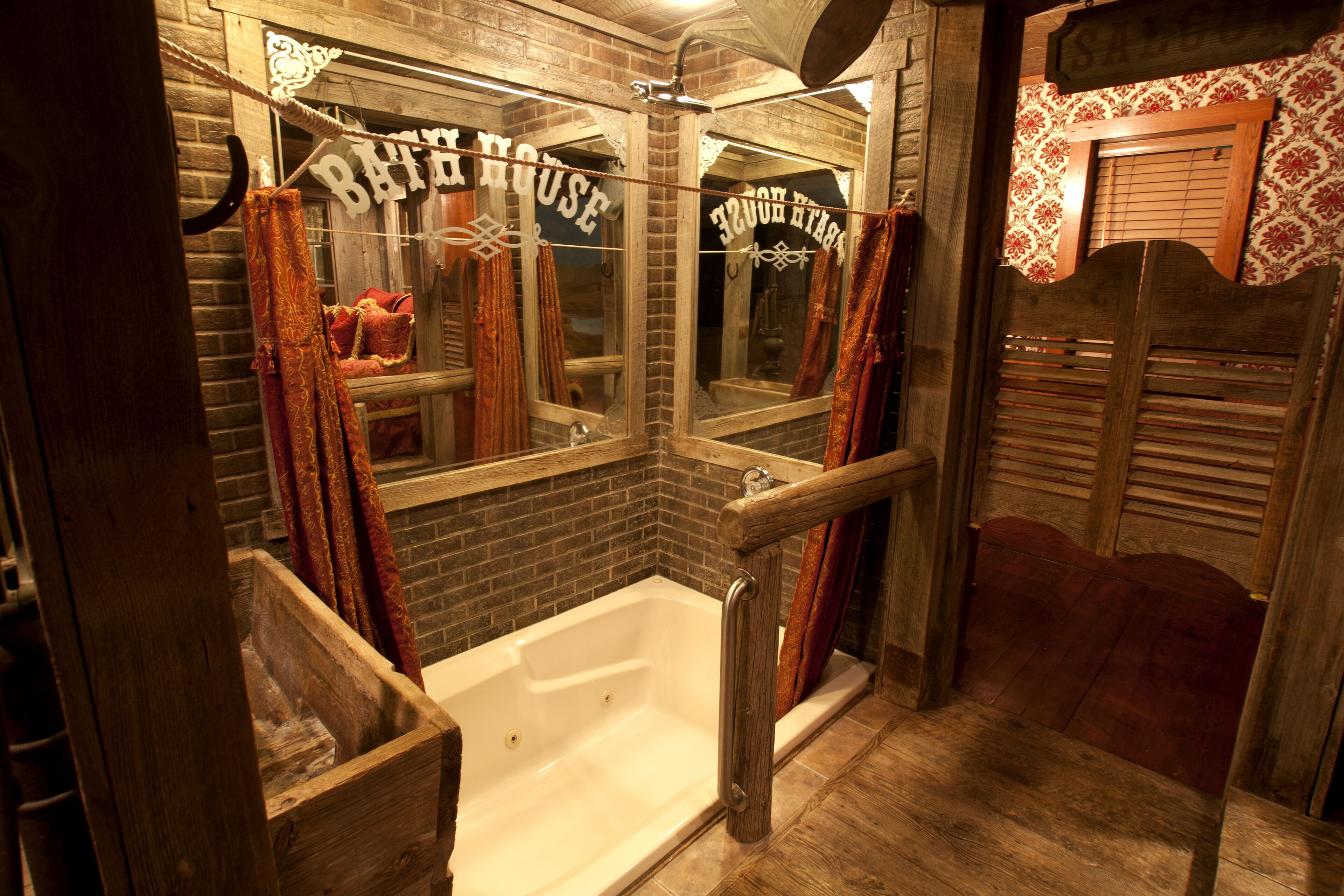 A rustic bathroom with a wooden bathtub, a mirror, and a sign that reads "Barber House."
