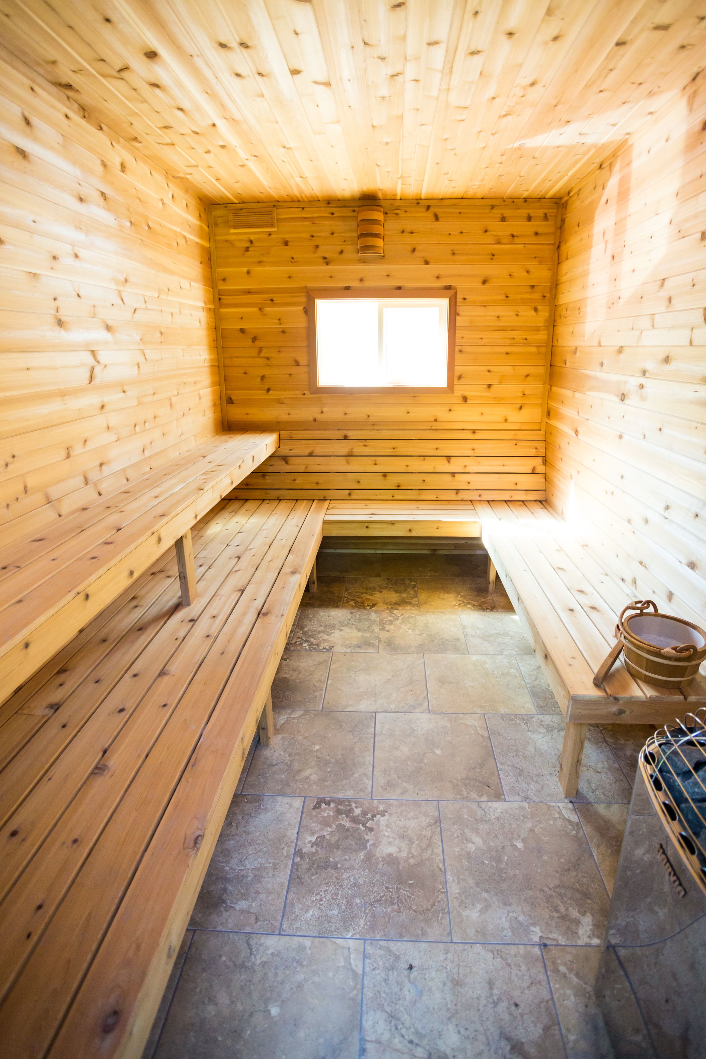 A sauna with wooden benches and a window.