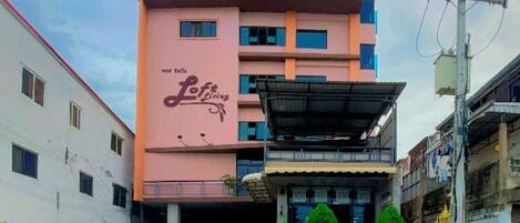A multi-story building with a sign reading "Lof Living."