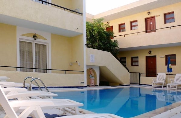 Seasonal outdoor pool, pool umbrellas, pool loungers