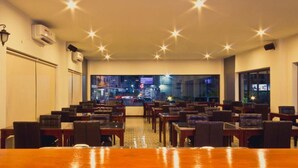 A restaurant with tables and chairs arranged for dining.