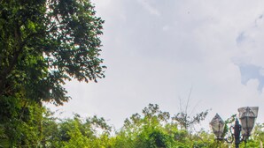 A pool with clear blue water, surrounded by rocks and greenery. - Ravine Hotel (Mahabaleshwar)