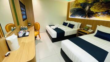 Deluxe Triple Room | Minibar, in-room safe, desk, laptop workspace