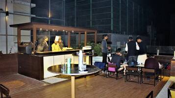 An outdoor dining area with a counter and seating.