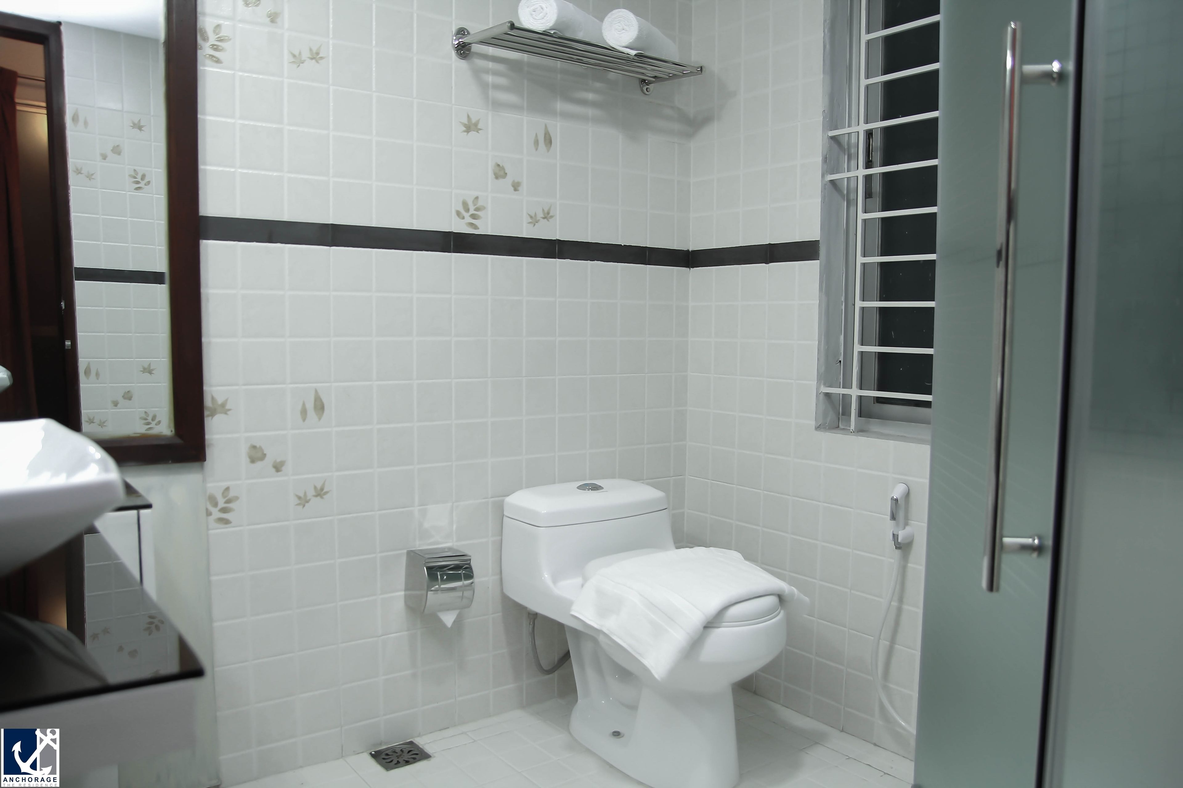 Un baño con inodoro, lavabo y zona de ducha.