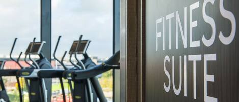 A fitness suite with treadmills and a sign indicating the suite's name.