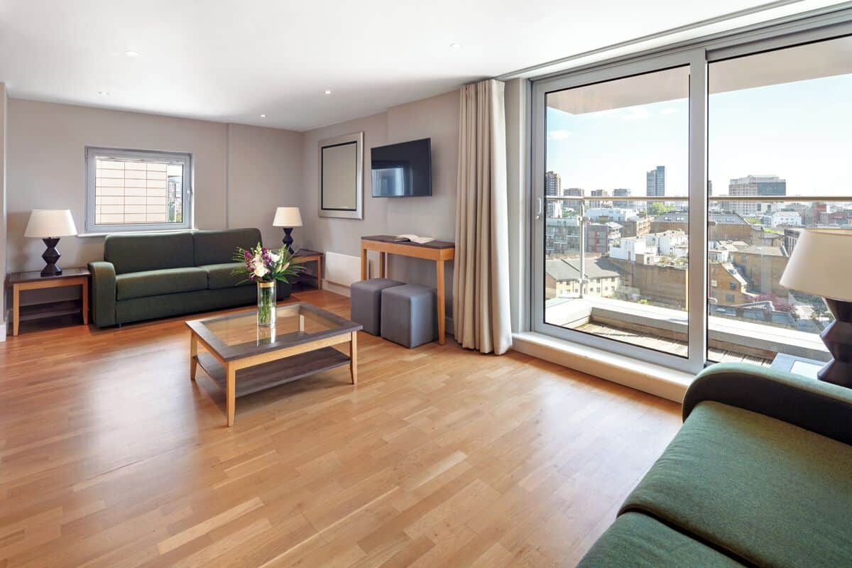 A modern living room with a sofa, a coffee table, and a TV.
