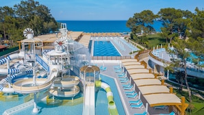 A cruise ship's pool area with multiple water slides, a large swimming pool, and sun loungers. - Baia Salima Kemer (Kemer)