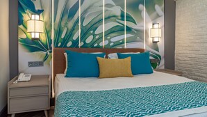 A hotel room with a large bed, a nightstand with a phone, and a wall with a leaf pattern. - Baia Salima Kemer (Kemer)