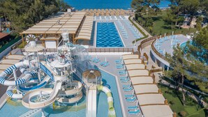 A cruise ship's pool area with multiple water slides and sun loungers. - Baia Salima Kemer (Kemer)
