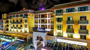 Um hotel com vários andares, com varandas e um letreiro com a inscrição 'DANGLER'S BOUTIQUE'.