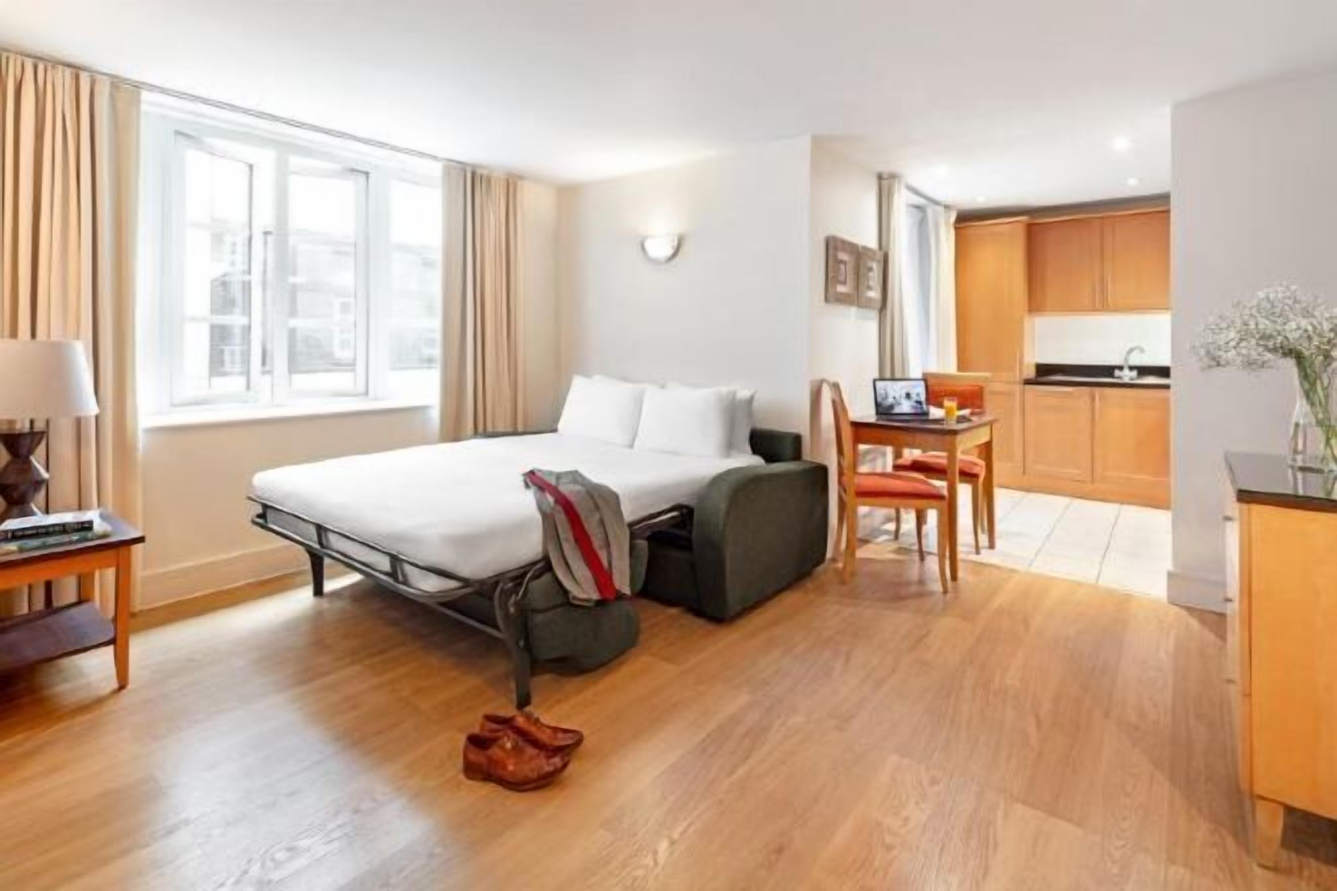 Desk, iron/ironing board, bed sheets