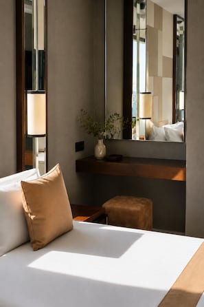 A hotel room with a bed, a nightstand, a mirror, a vase with flowers, and a view of the room's interior. - The Biancho Hotel Pera (Istanbul)