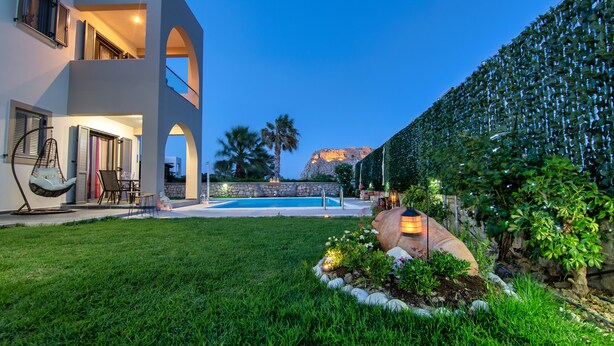 A modern two-story house with a swimming pool, outdoor seating, and a well-maintained garden. - Haraki Villas (Rhodes)