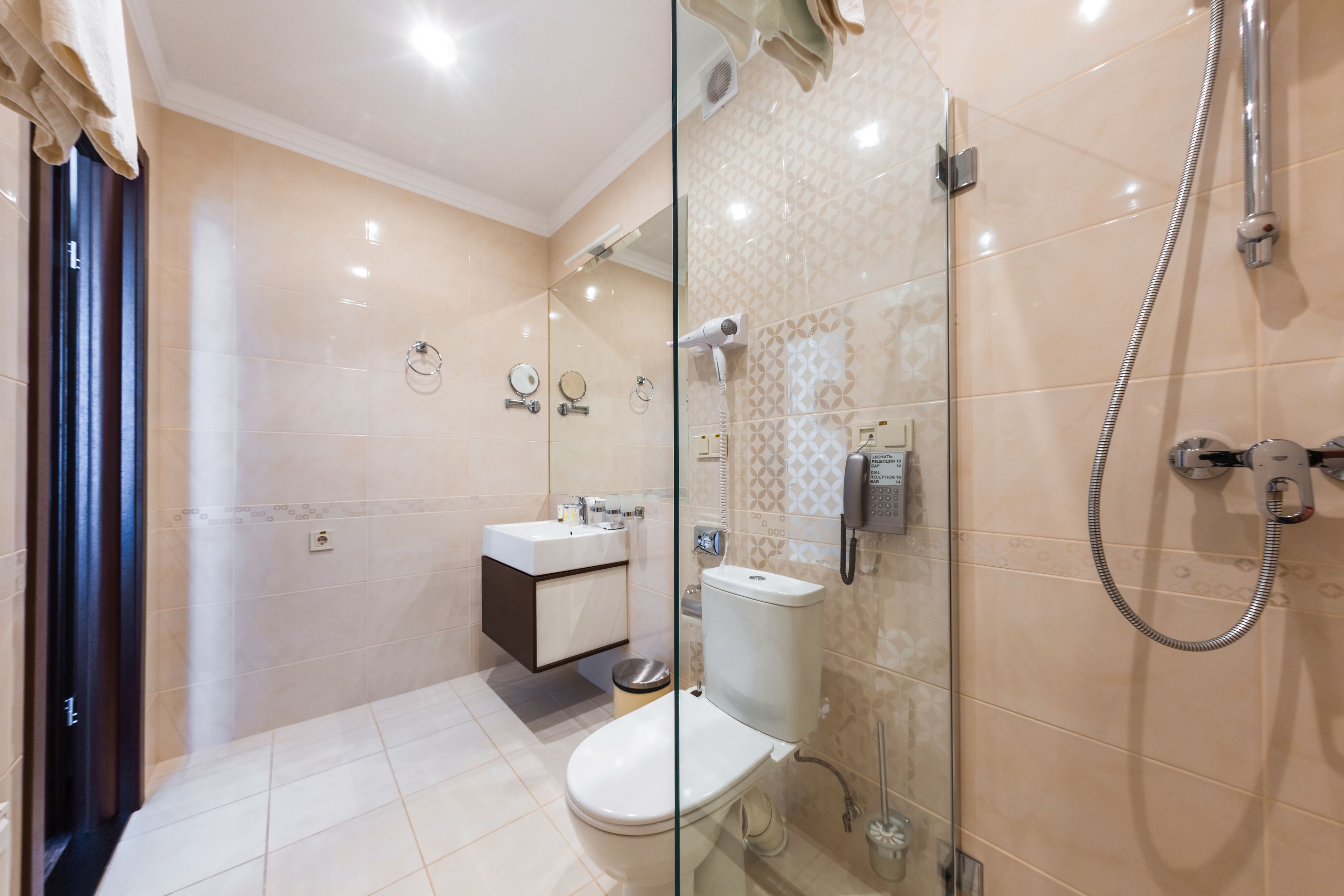 A modern bathroom with a glass shower enclosure, a toilet, and a vanity with a sink.