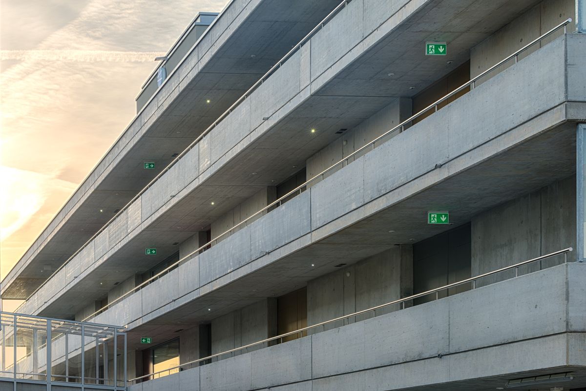 A multi-level parking structure with concrete floors and railings.
