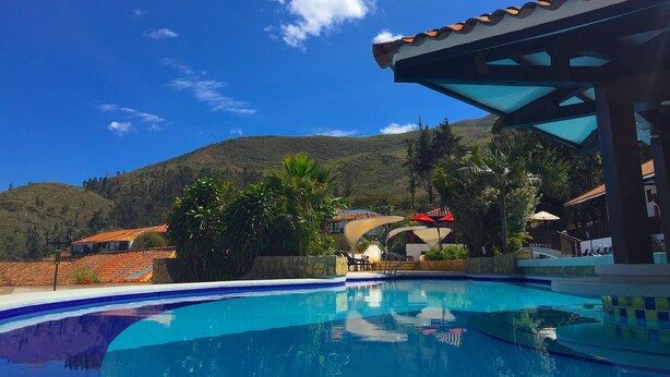 A swimming pool with a clear view of a mountain in the background.