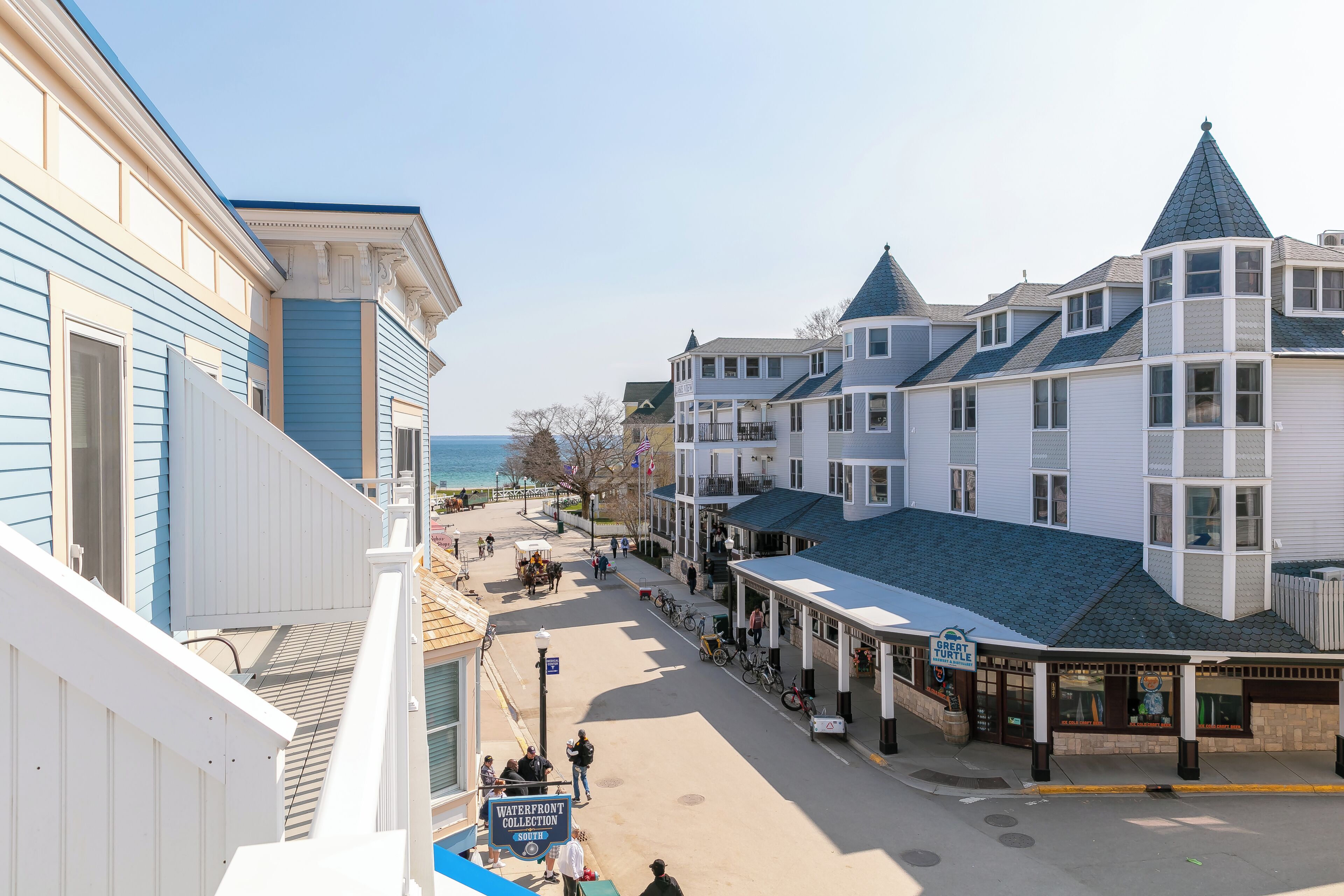 A coastal town with a waterfront collection store, a covered walkway, and buildings with gabled roofs.