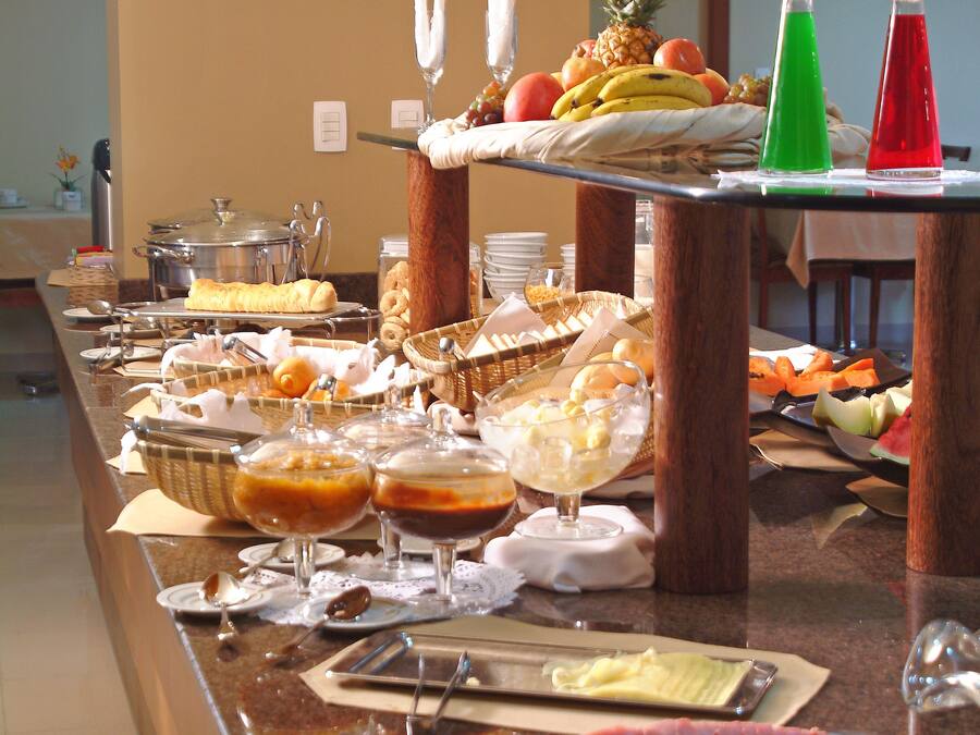 A buffet with various food items and beverages.