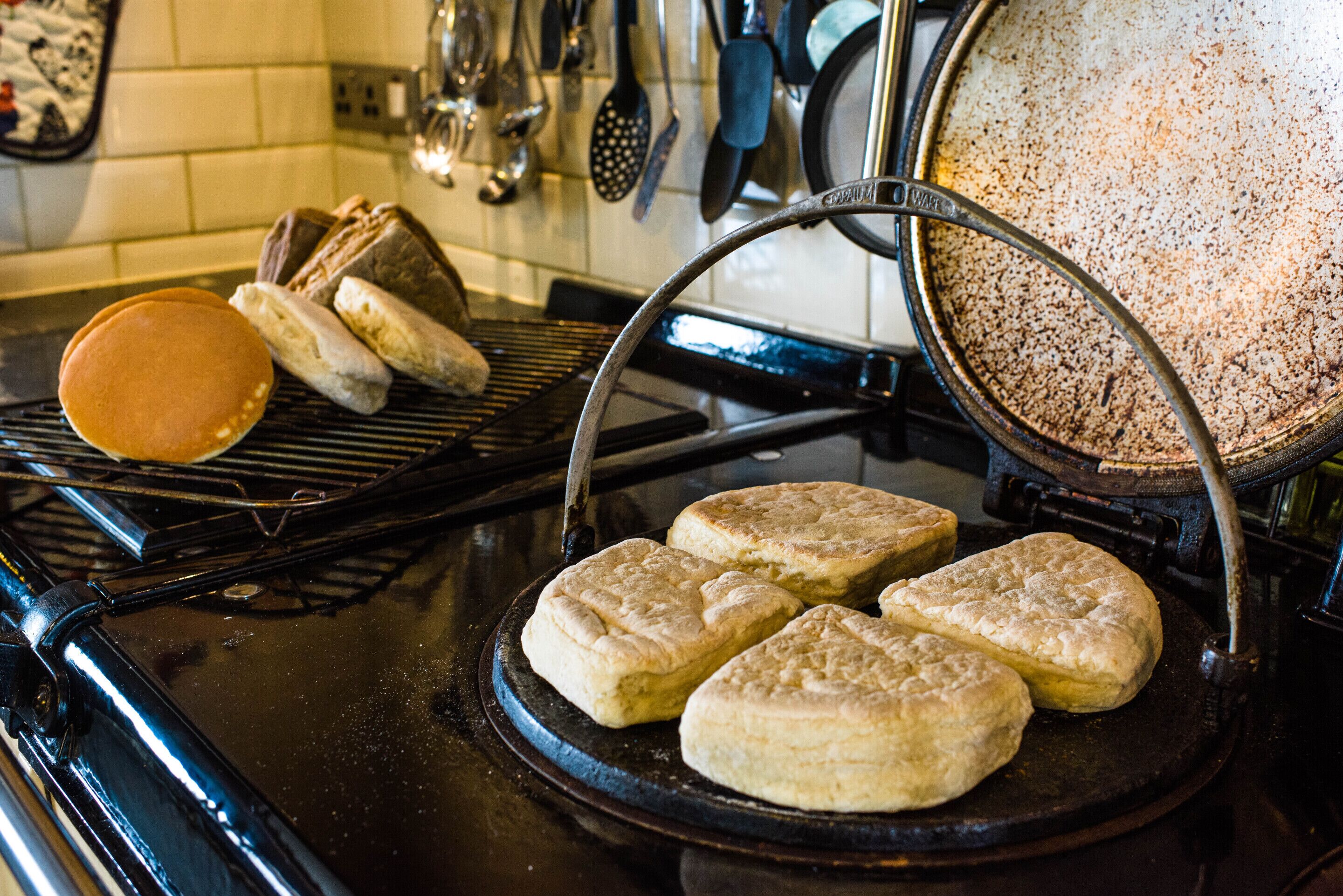 A kitchen with a griddle, a frying pan, and a spatula.
